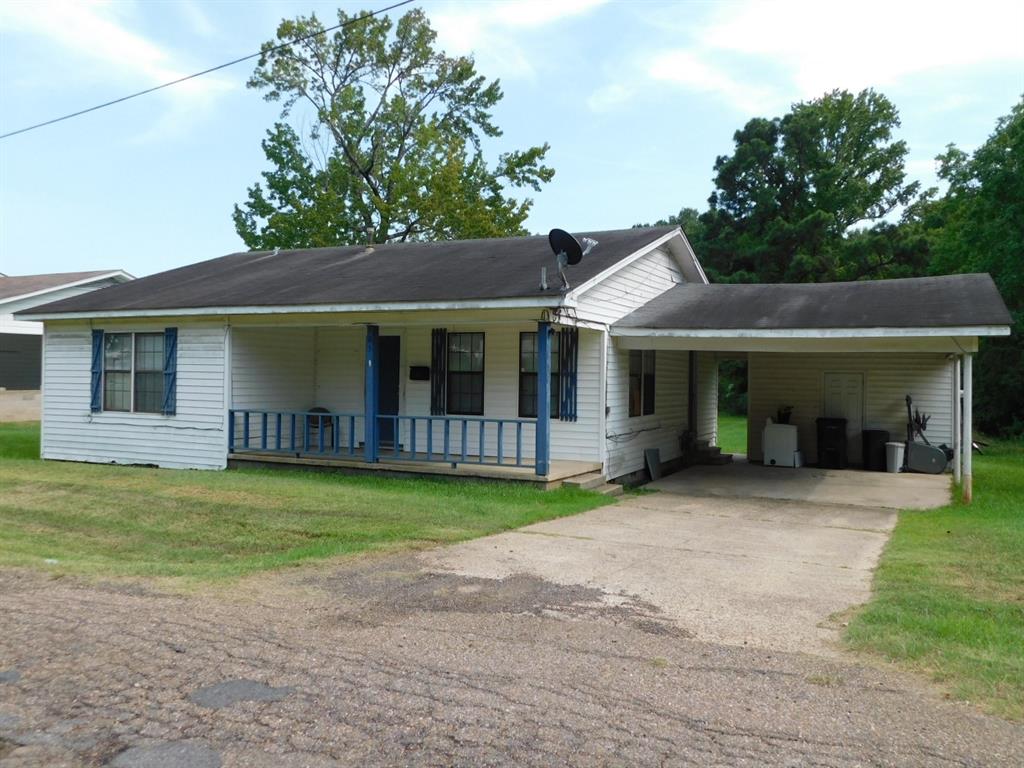 a front view of a house with a garden and porch