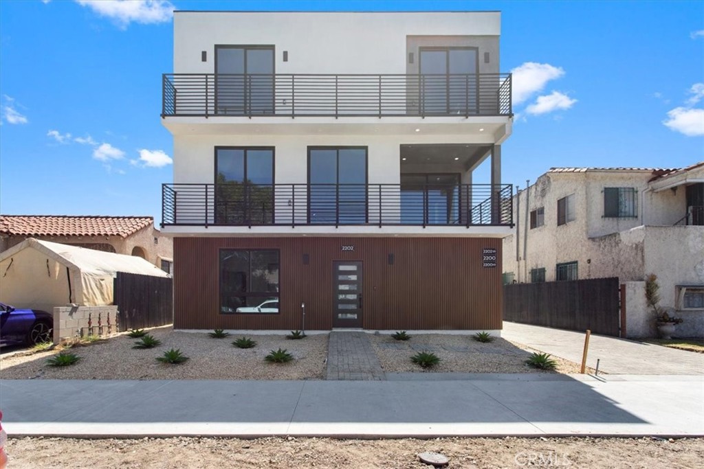 a front view of a building with a garden