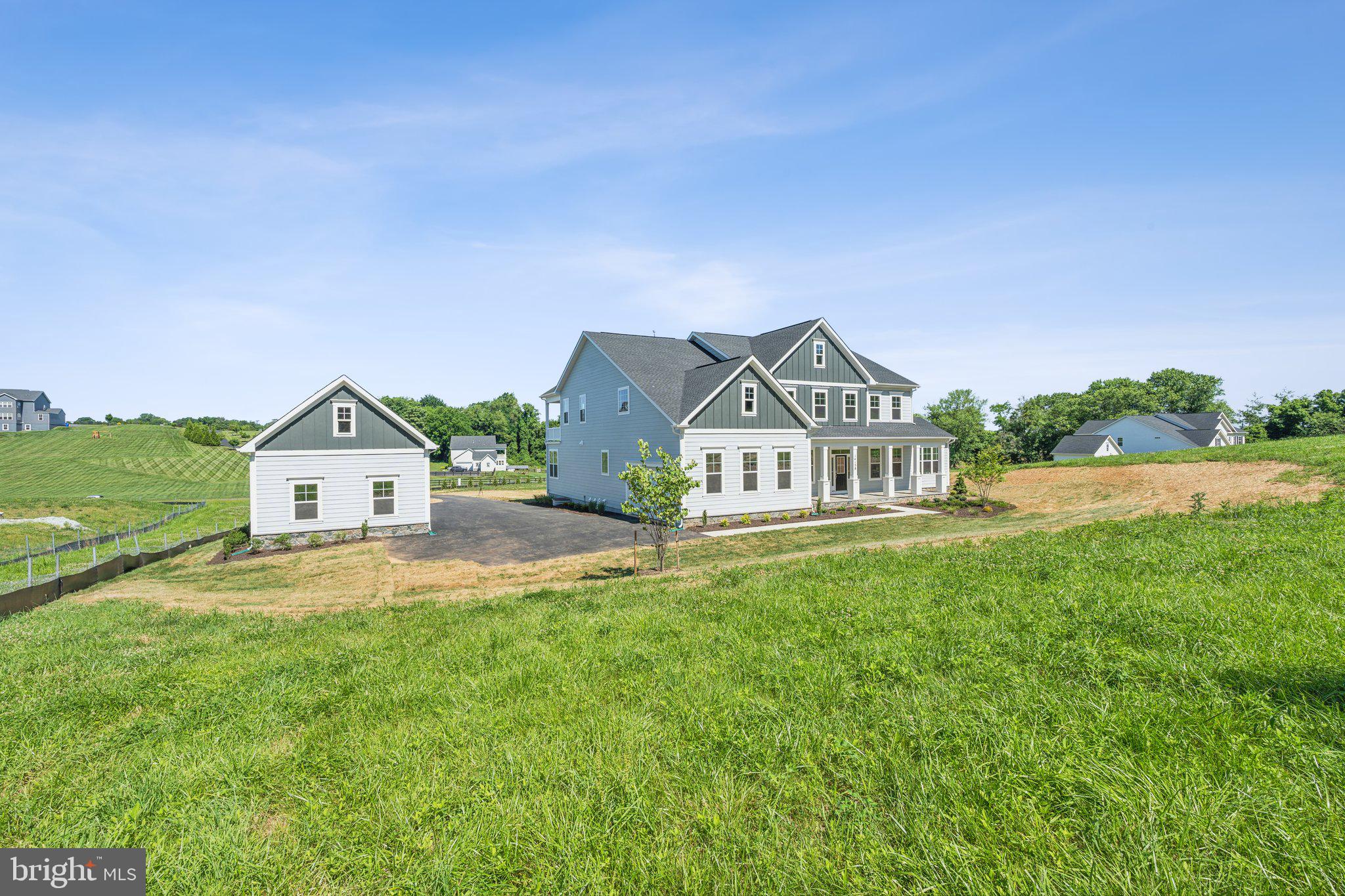 a view of house with yard and green space