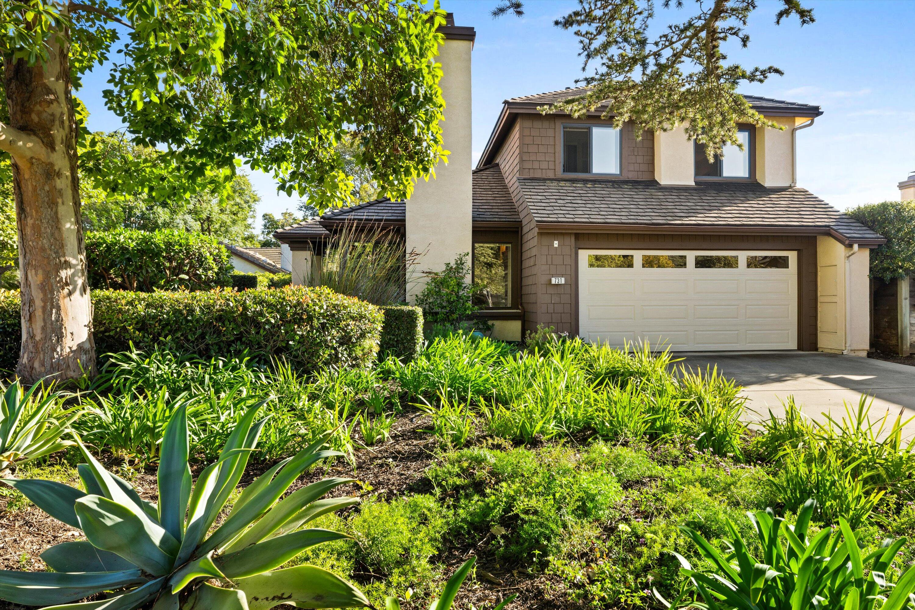 a front view of a house with garden