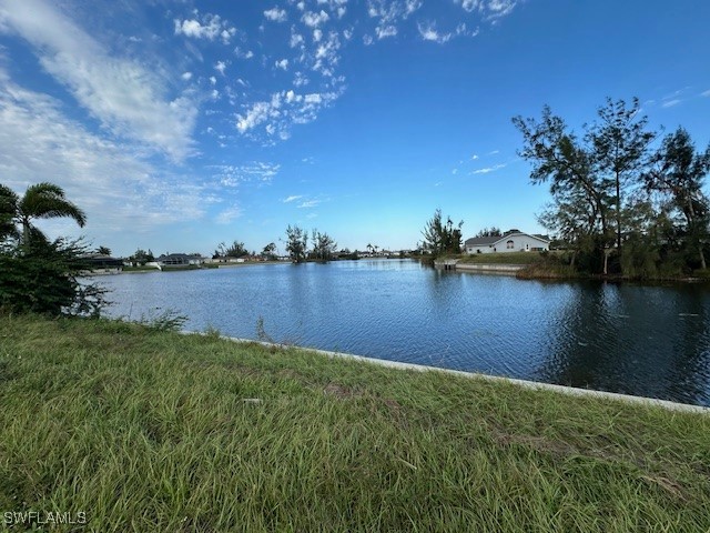 a view of a lake with houses in the back