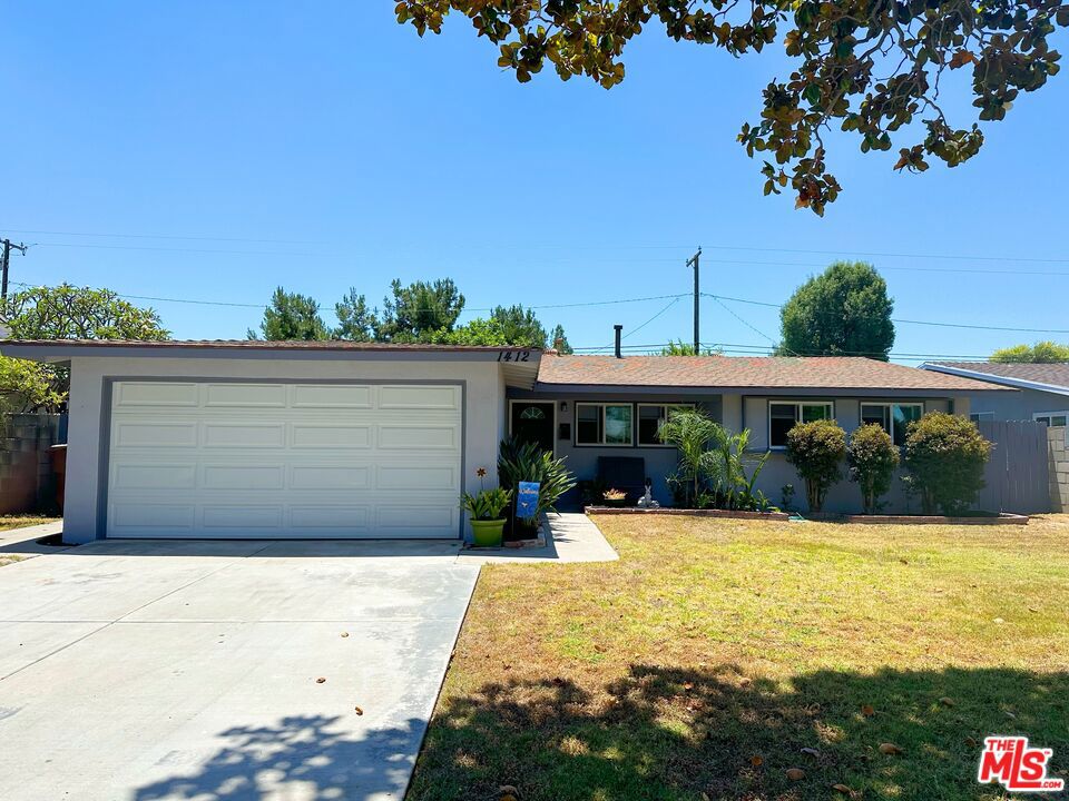 a view of a house with yard and sitting area