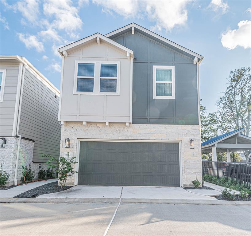 a front view of a house with garage