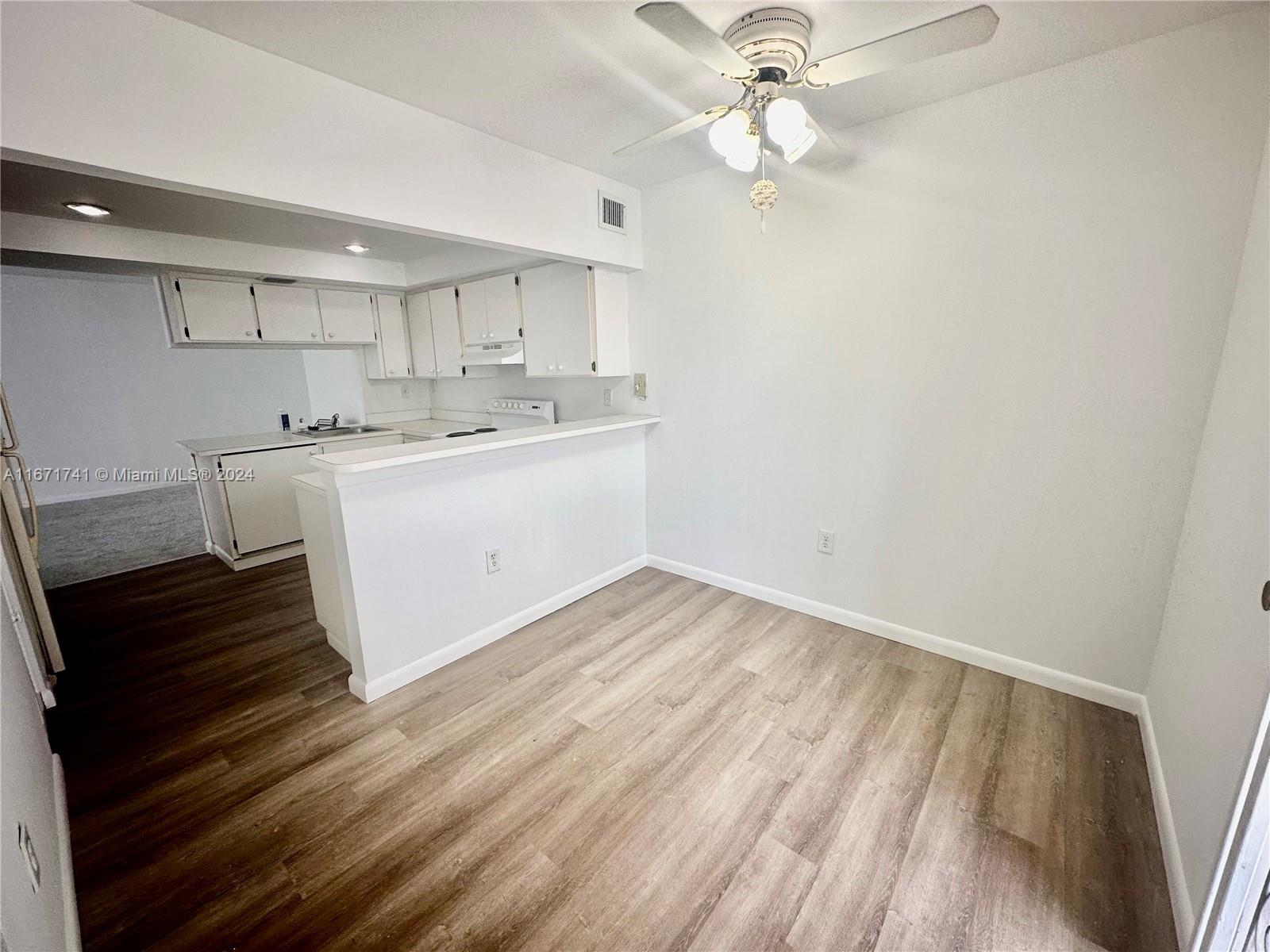 a view of kitchen with sink and wooden floor