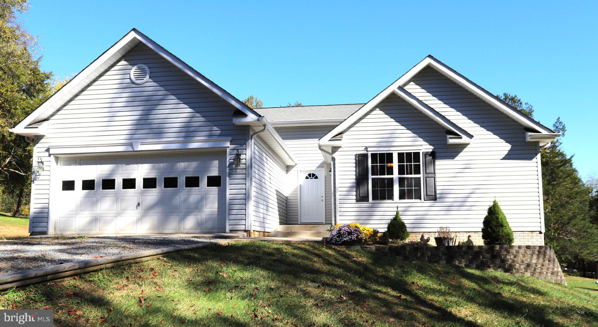 a front view of house with yard and car parked