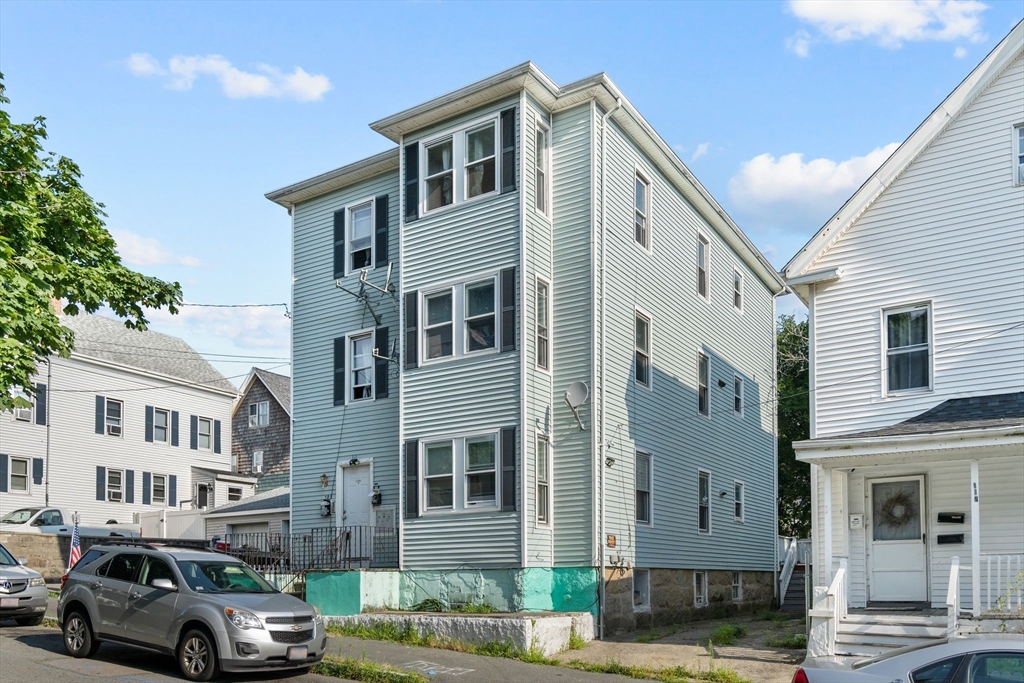 a front view of a residential apartment building with a yard