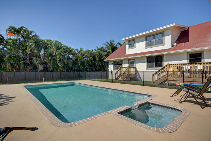 a view of a house with pool porch and chairs