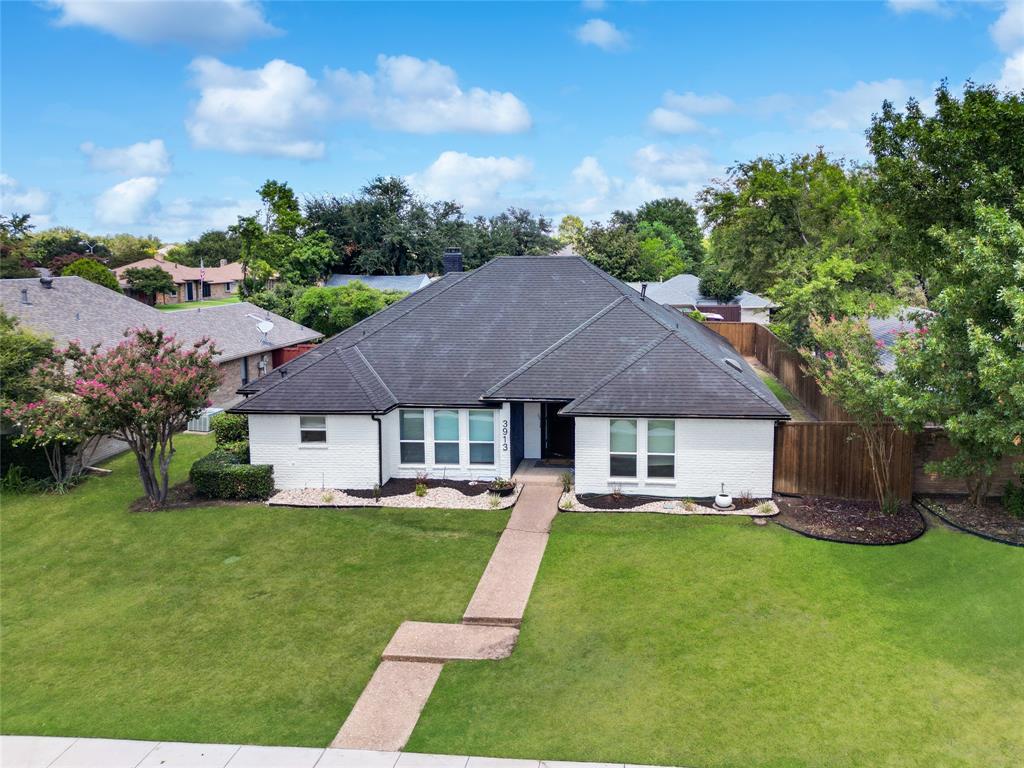 a aerial view of a house with swimming pool and garden