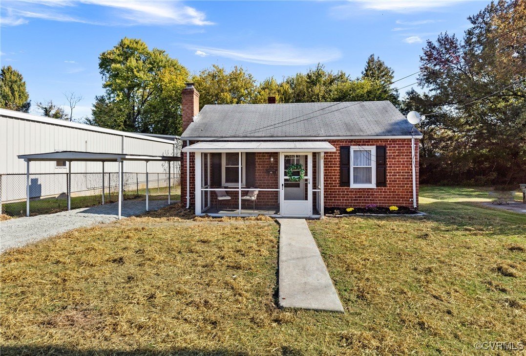 View of front of home with a front lawn and a sunr