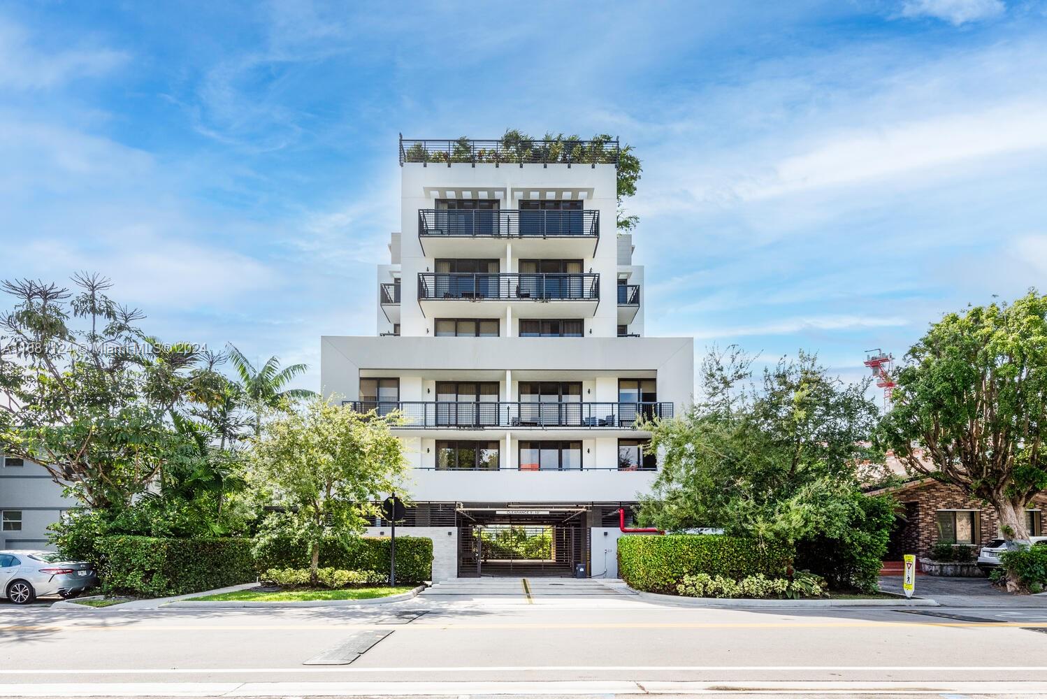 front view of a building with a garden