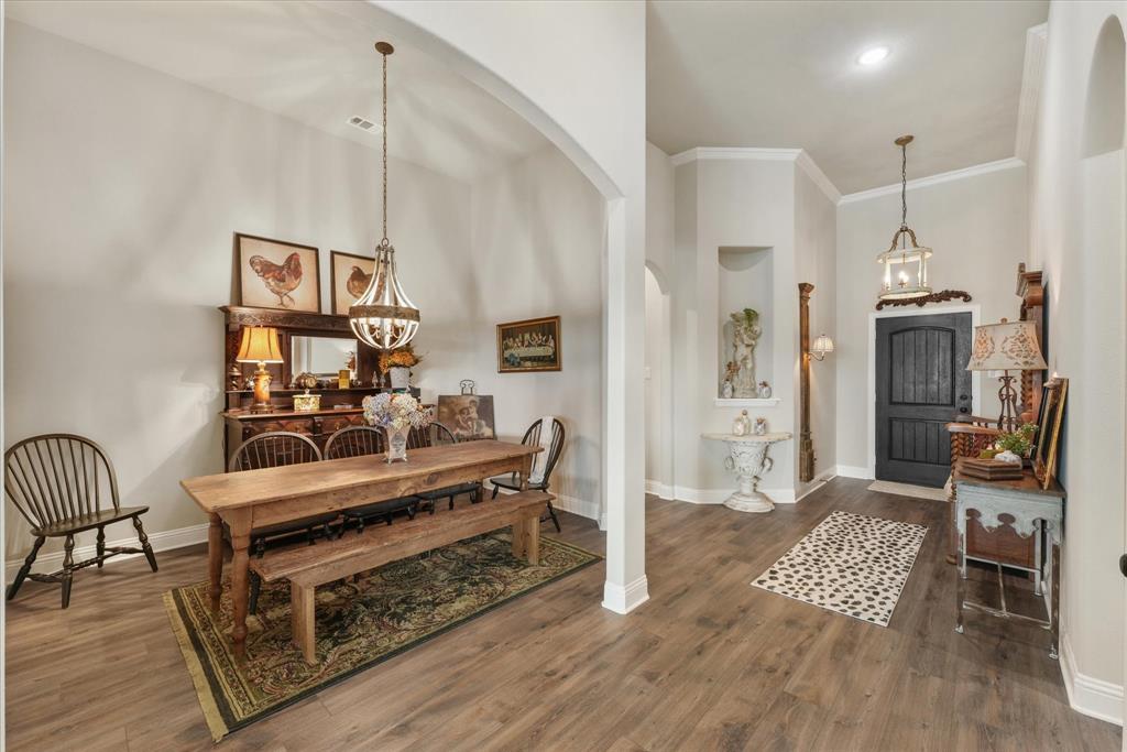 a living room with furniture a rug and a piano