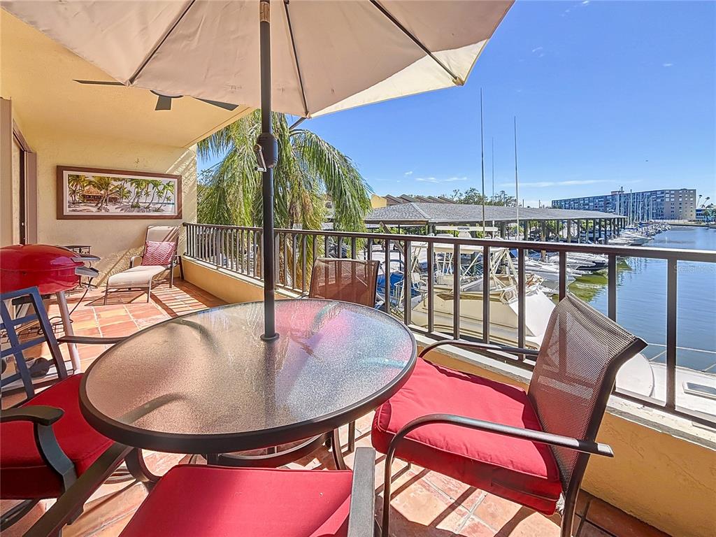 a balcony with table and chairs