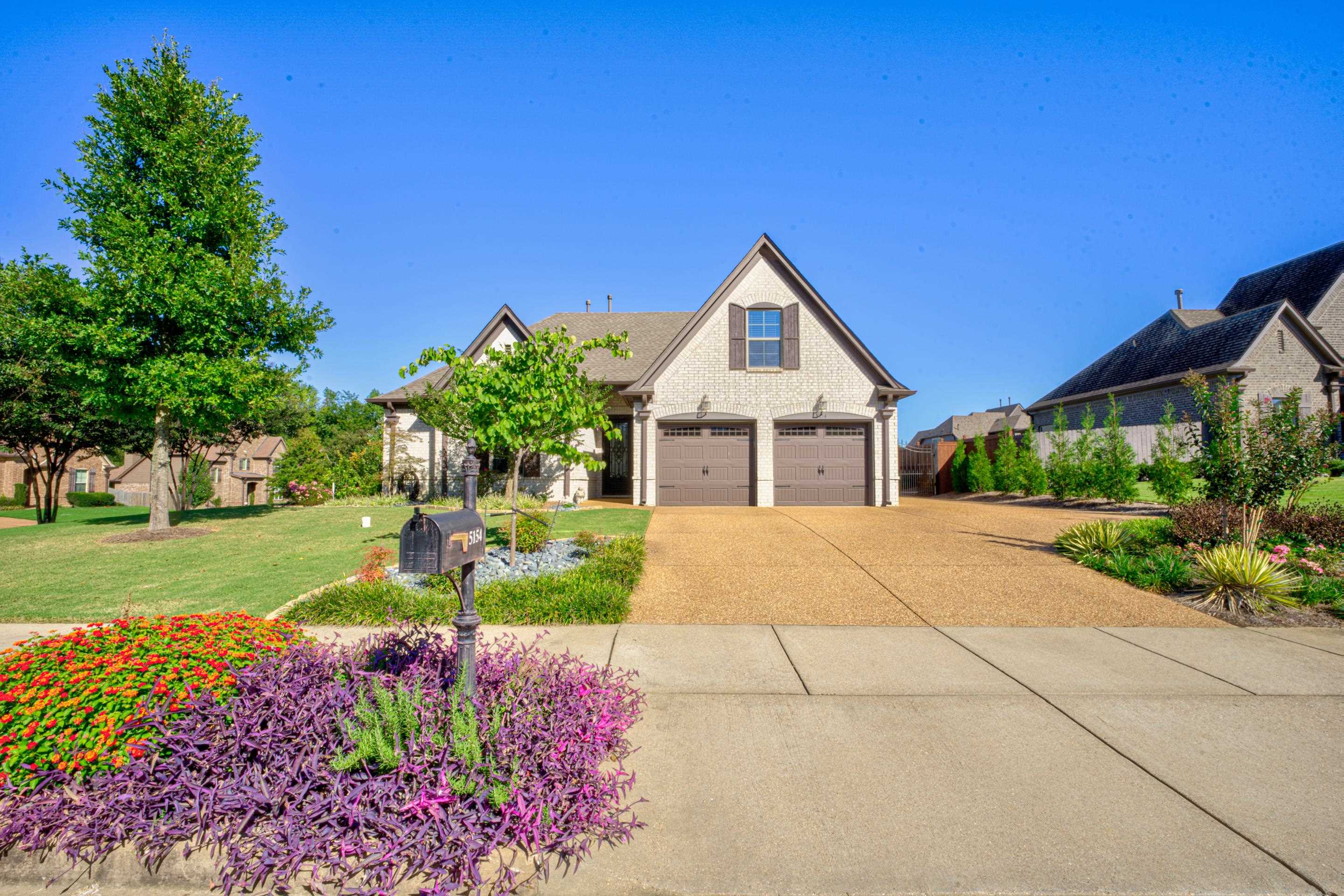 View of front of house with a garage and a front yard