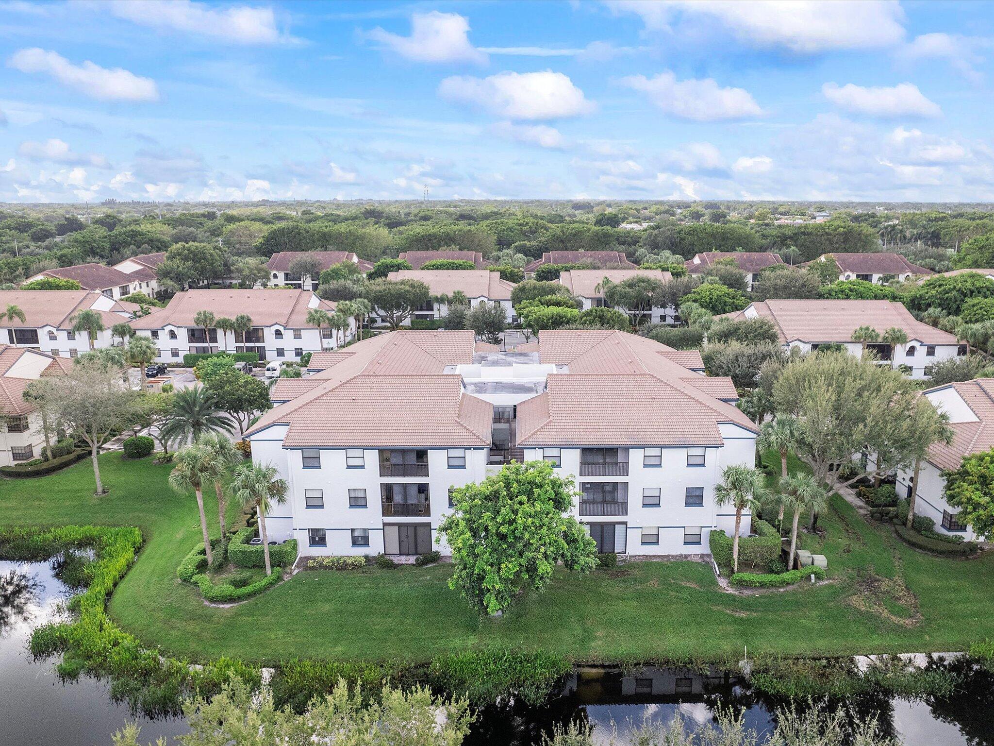 an aerial view of residential houses with outdoor space and trees