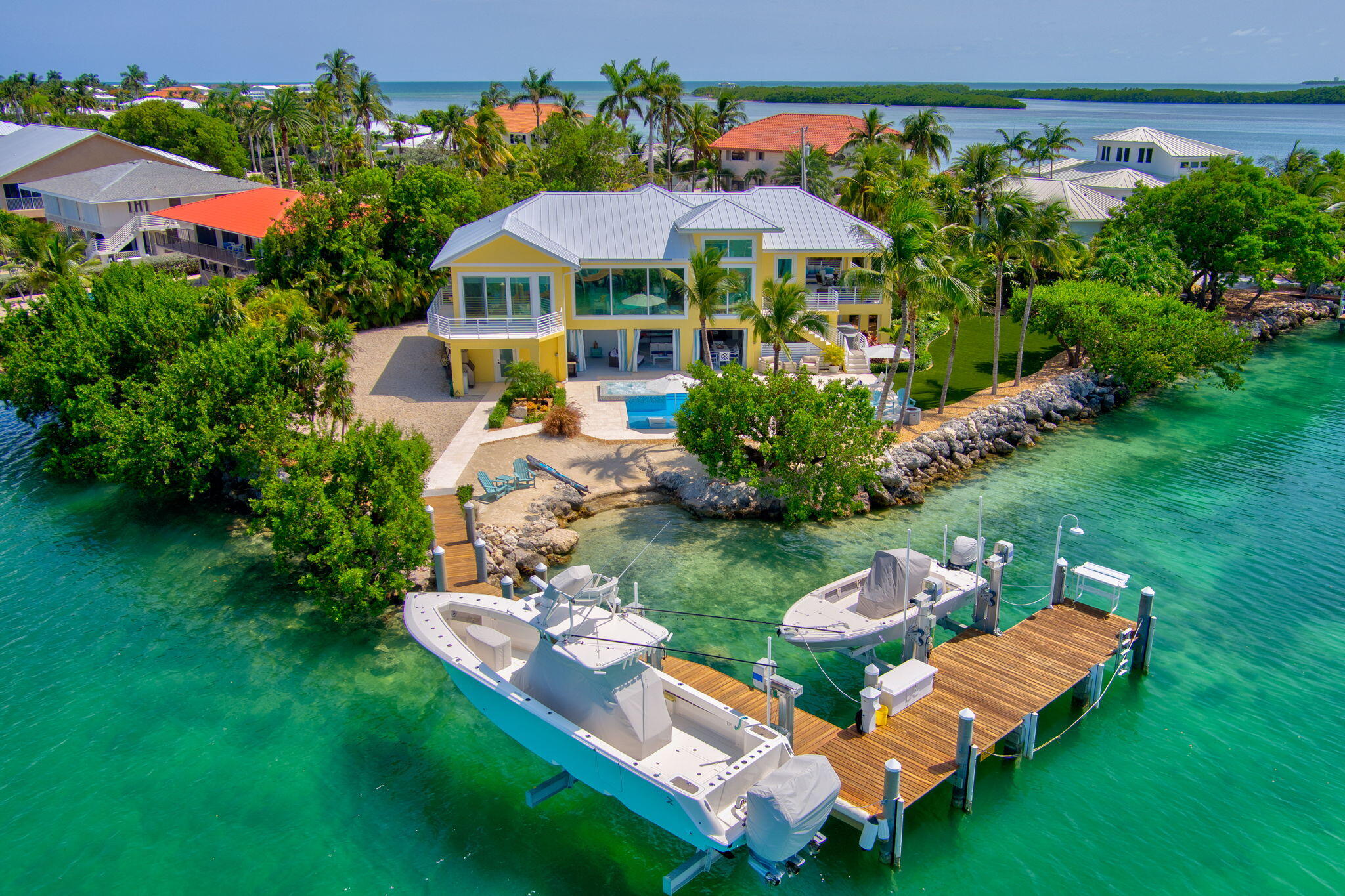 an aerial view of a house with swimming pool a patio and yard