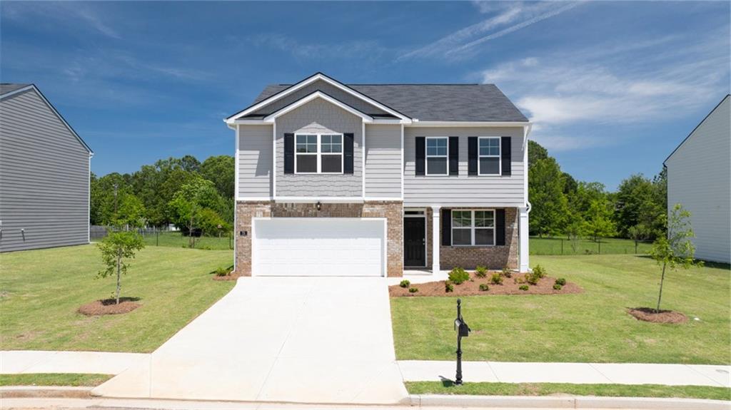 a front view of a house with a yard