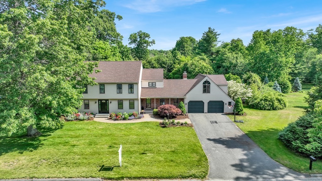 a front view of house with yard and green space