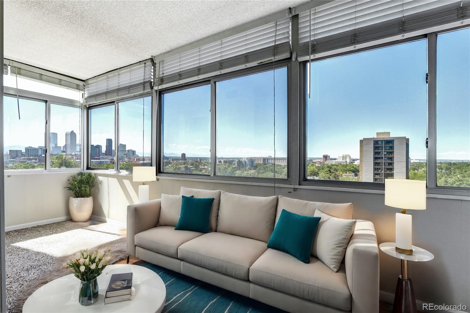 a living room with furniture and a floor to ceiling window