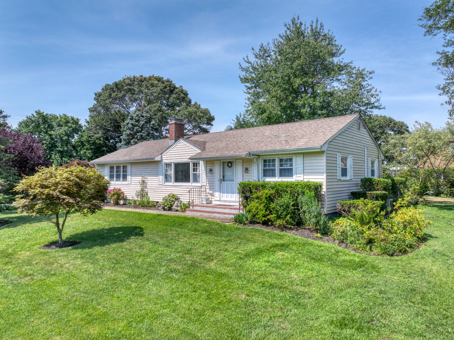 a front view of a house with a yard and porch