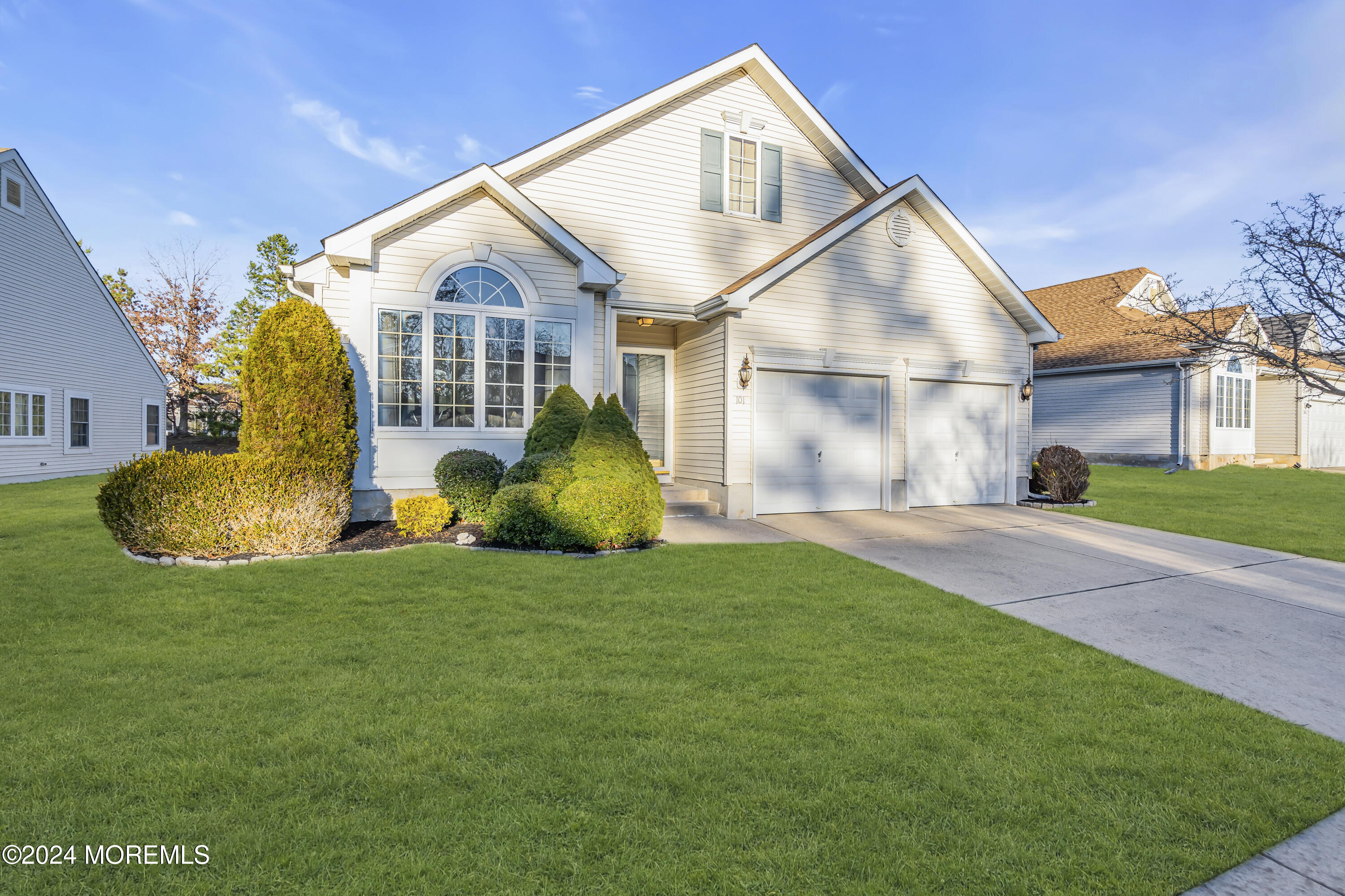 a front view of house with yard and green space