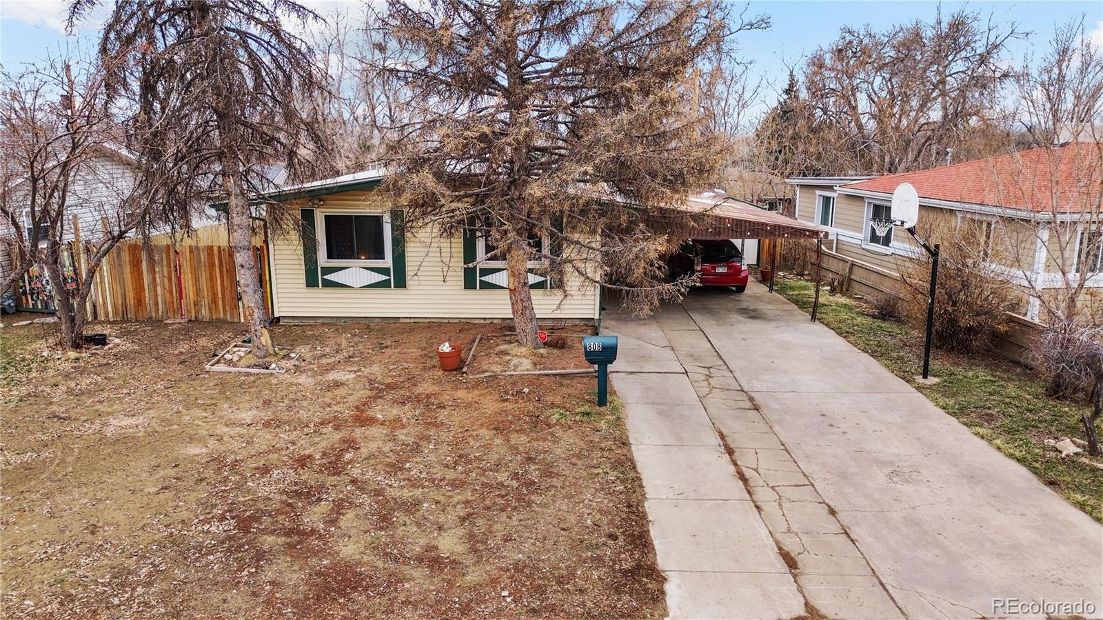 a view of a backyard that has a tree on the side