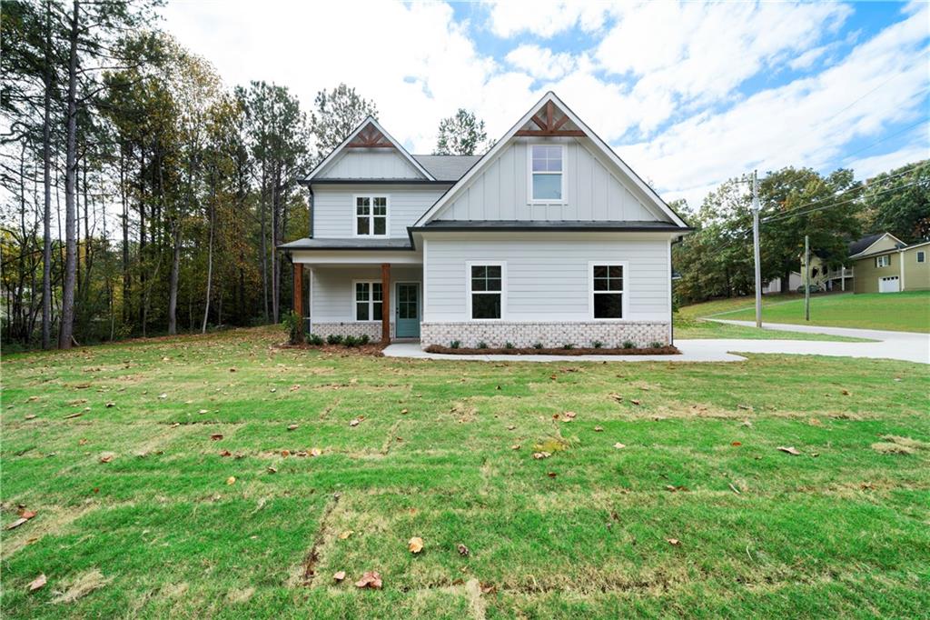 a front view of house with yard and green space