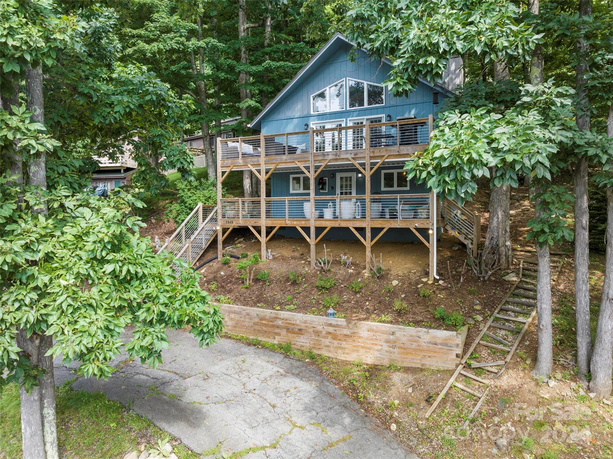 a view of a wooden house with a yard