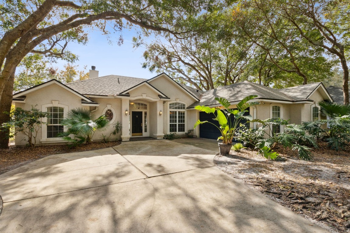 a view of a house with a tree in the background