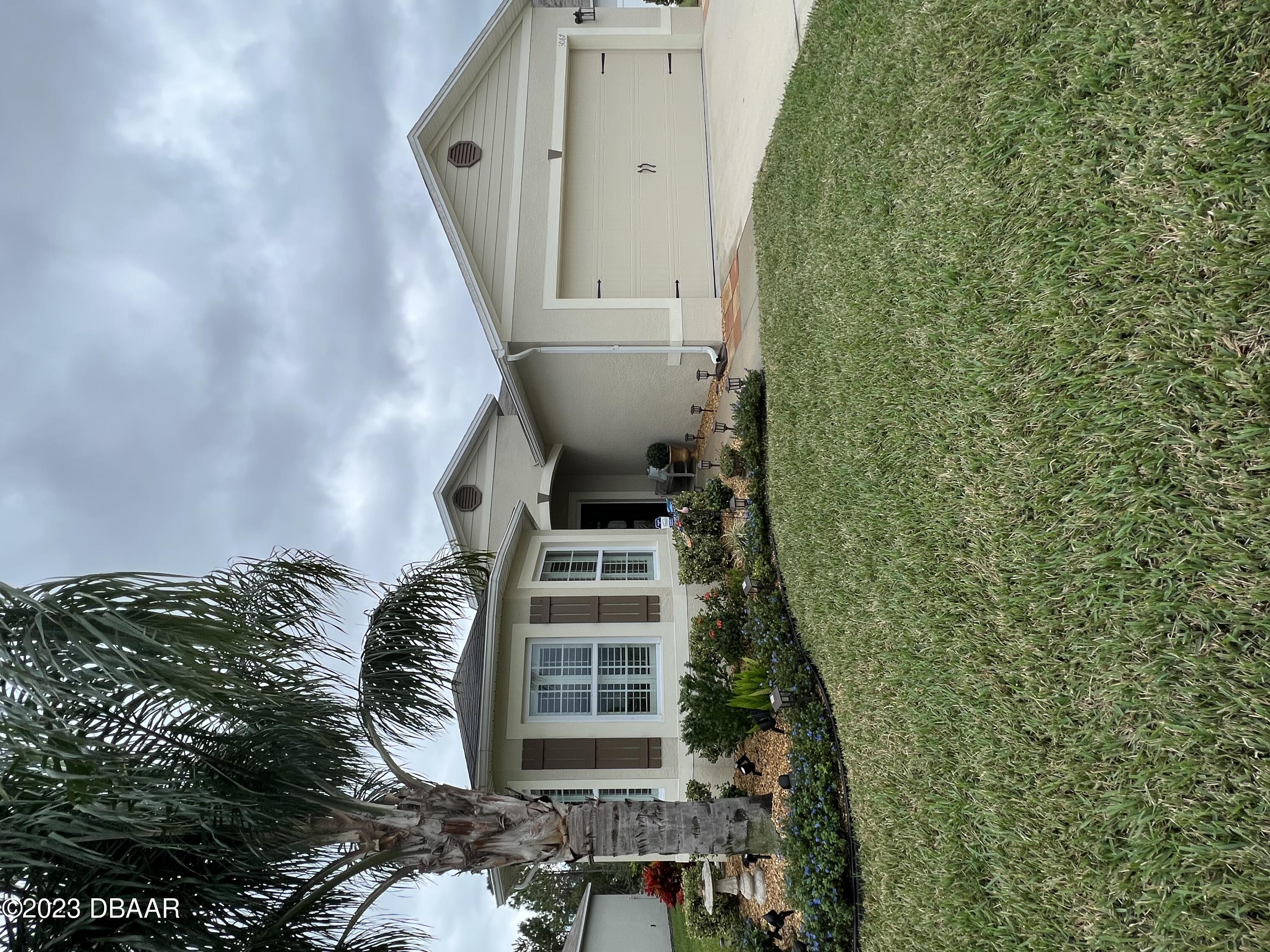 a front view of house with yard and green space