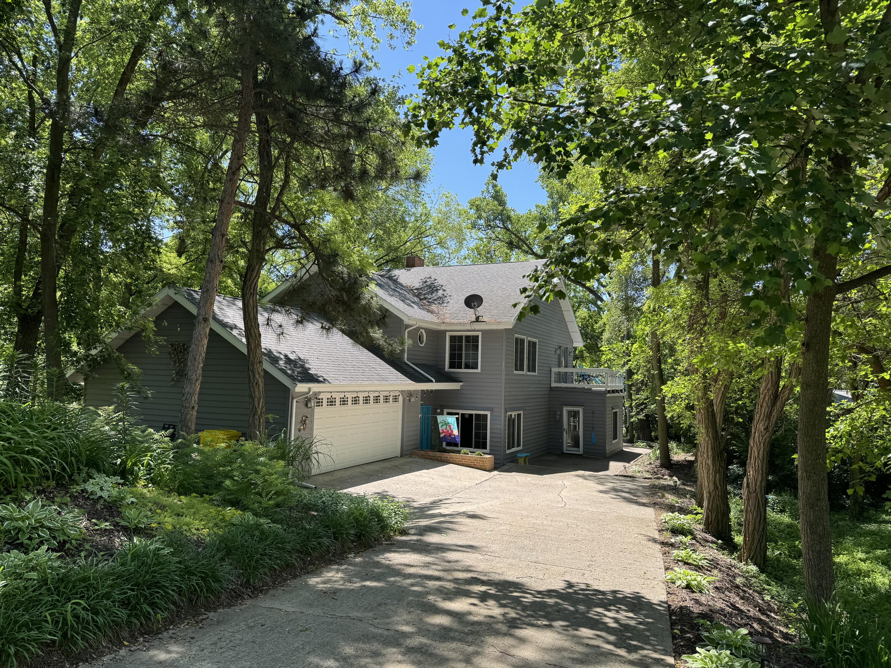 a front view of a house with a tree