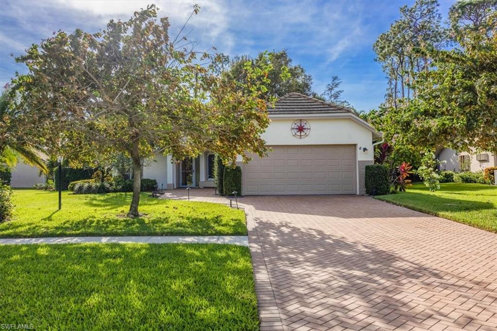 a view of a house with a yard and tree s