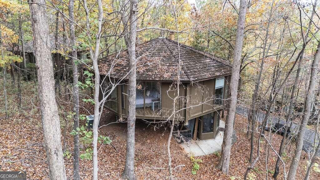 a aerial view of a house with balcony and trees