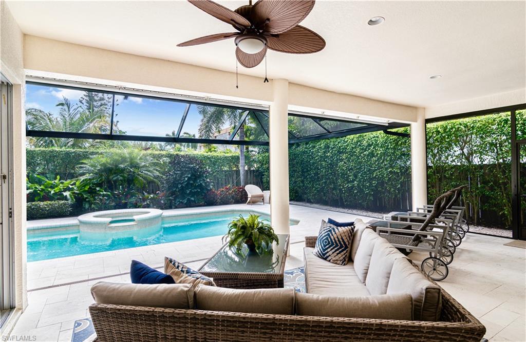 a living room with furniture and a floor to ceiling window