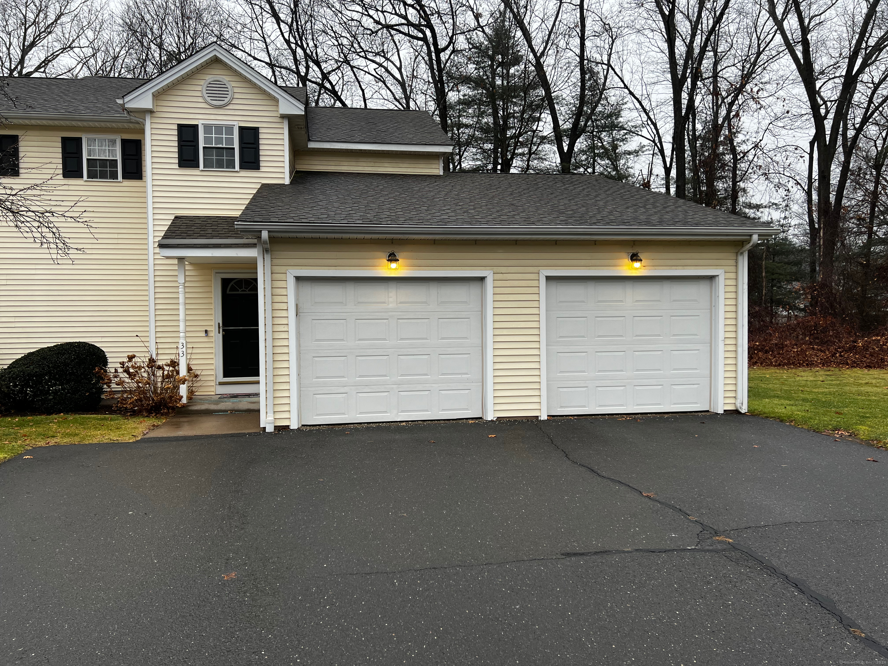 a front view of a house with a yard and garage