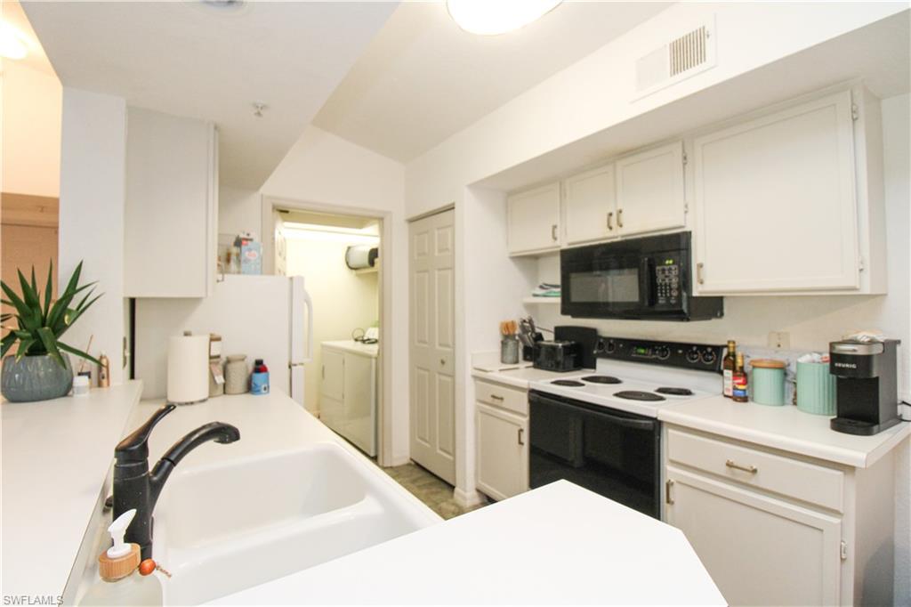 a kitchen with a sink stove and refrigerator