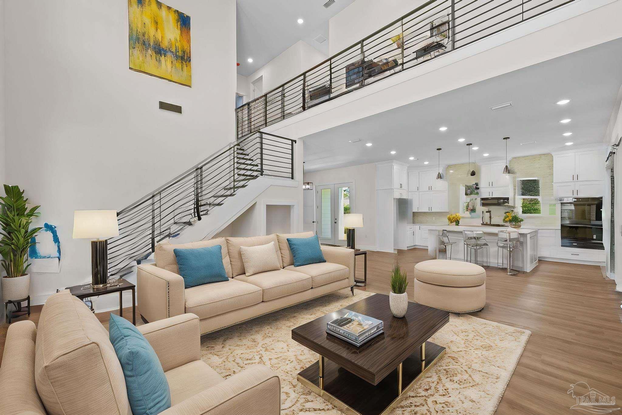 a living room with furniture and kitchen view