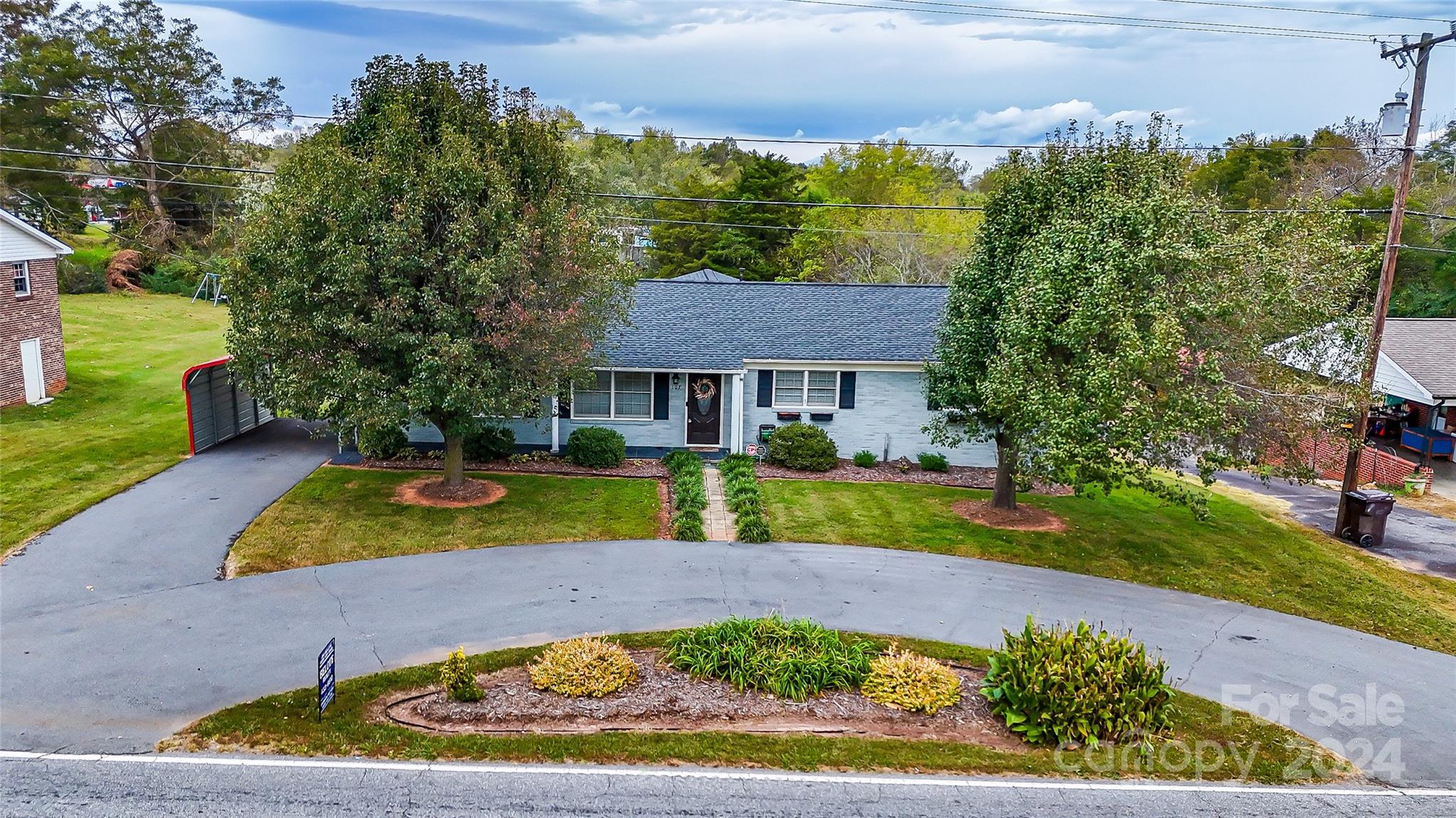 a view of house with outdoor space garden and swimming pool