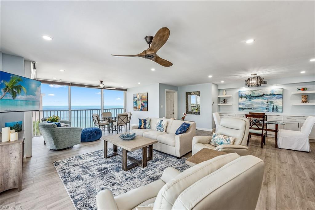 a living room with furniture a rug and a chandelier