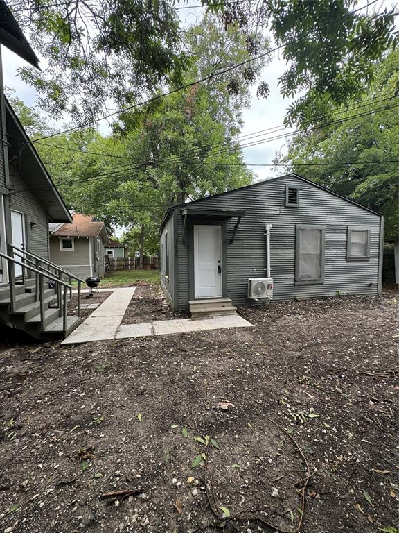 a view of a house with a yard and large tree