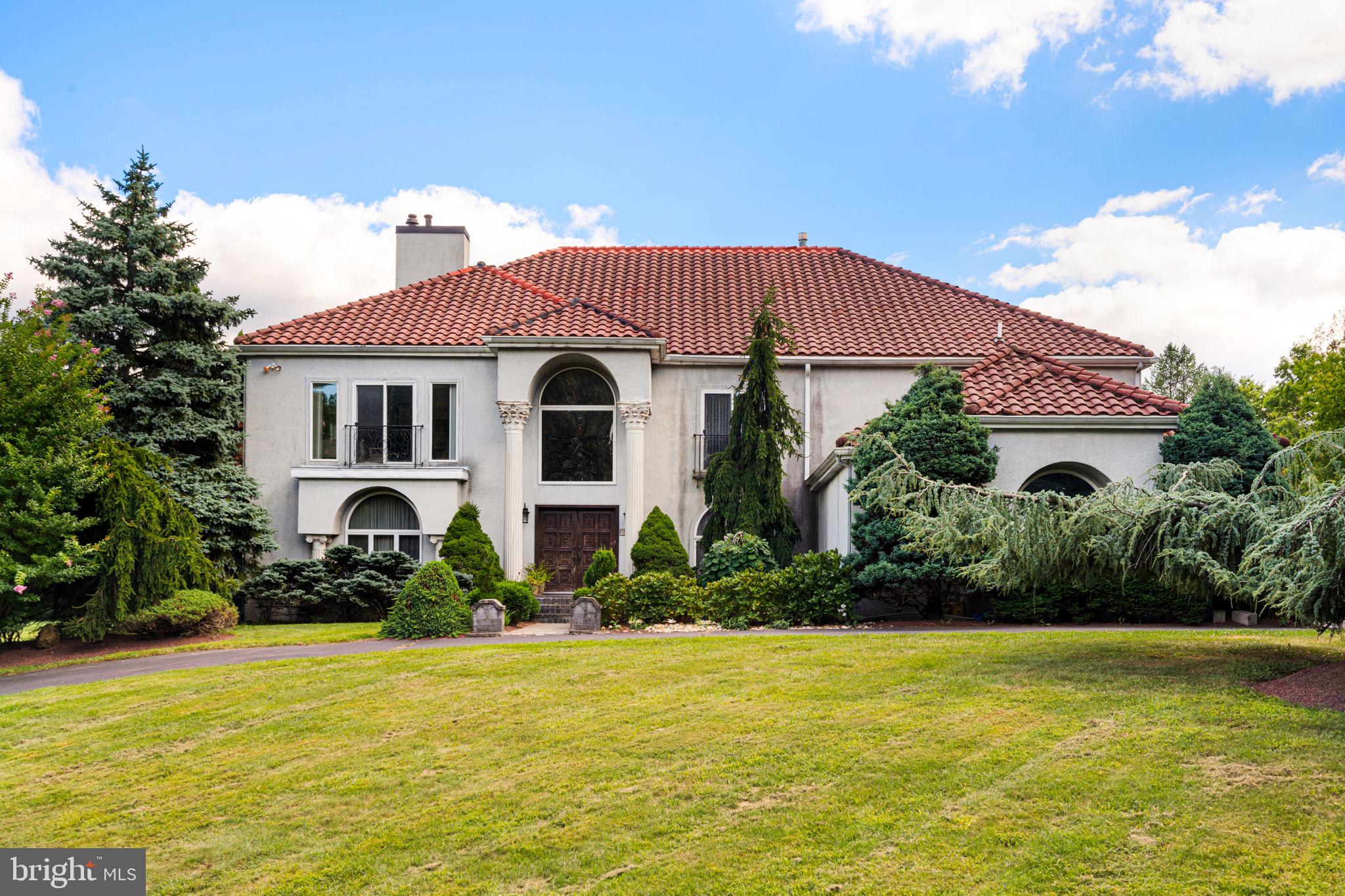 a large house with a large pool in front of it