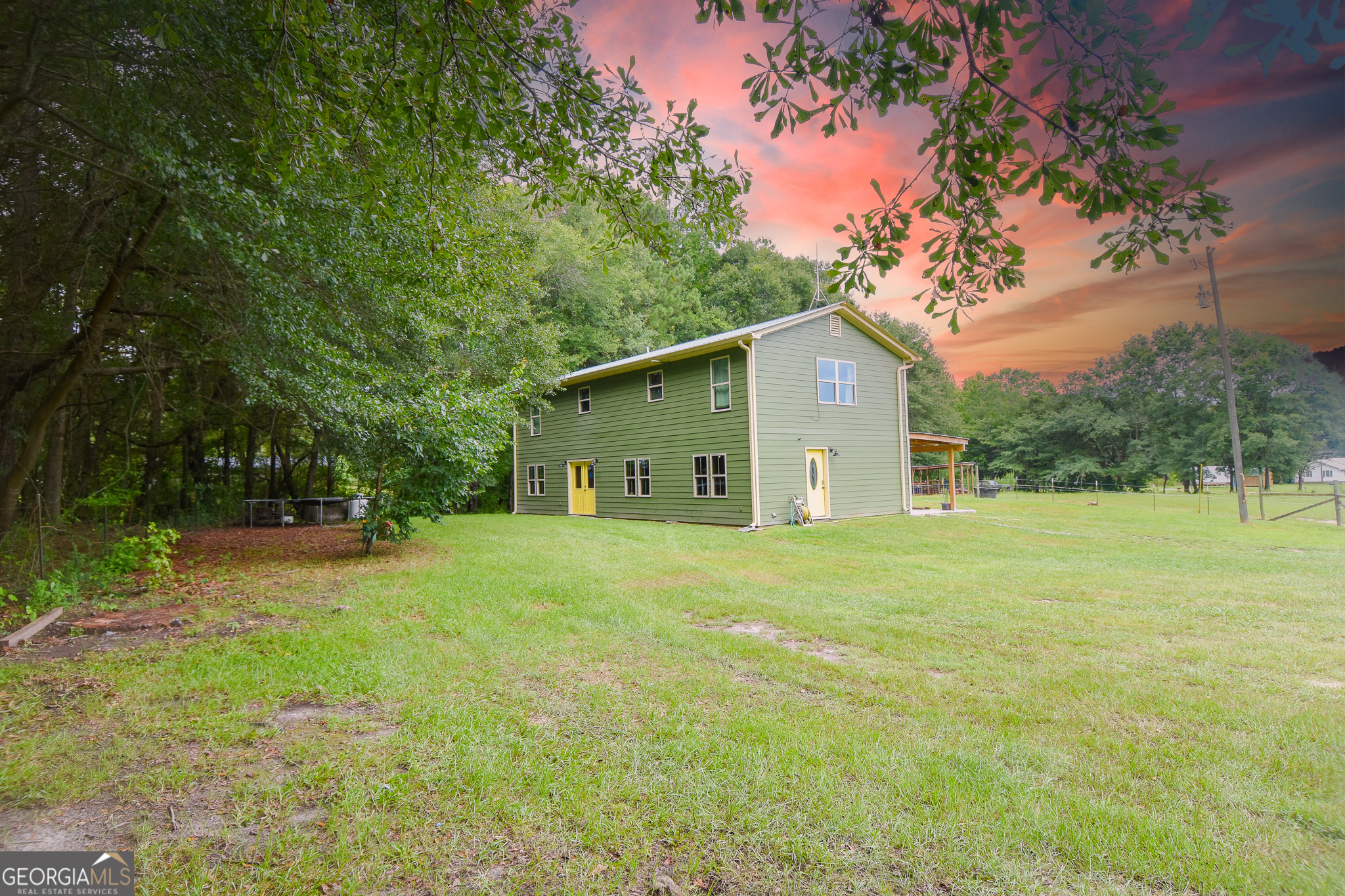 a view of a backyard with large trees