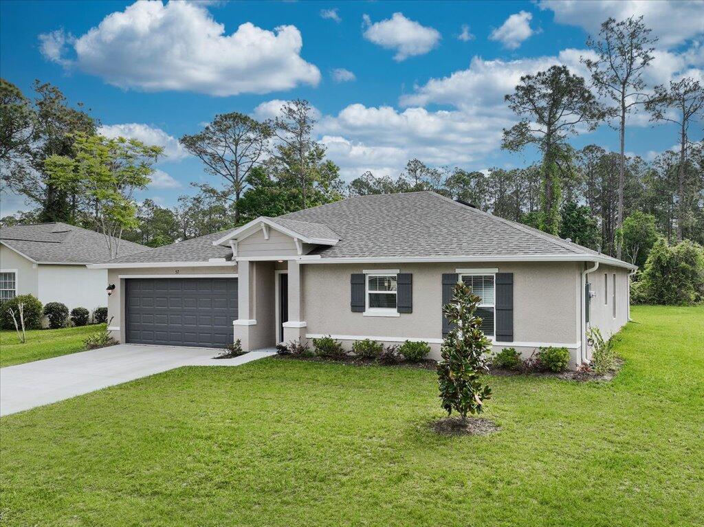 a front view of house with yard and green space