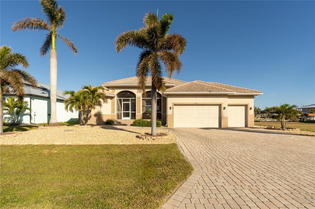 a view of a house with a yard and garage