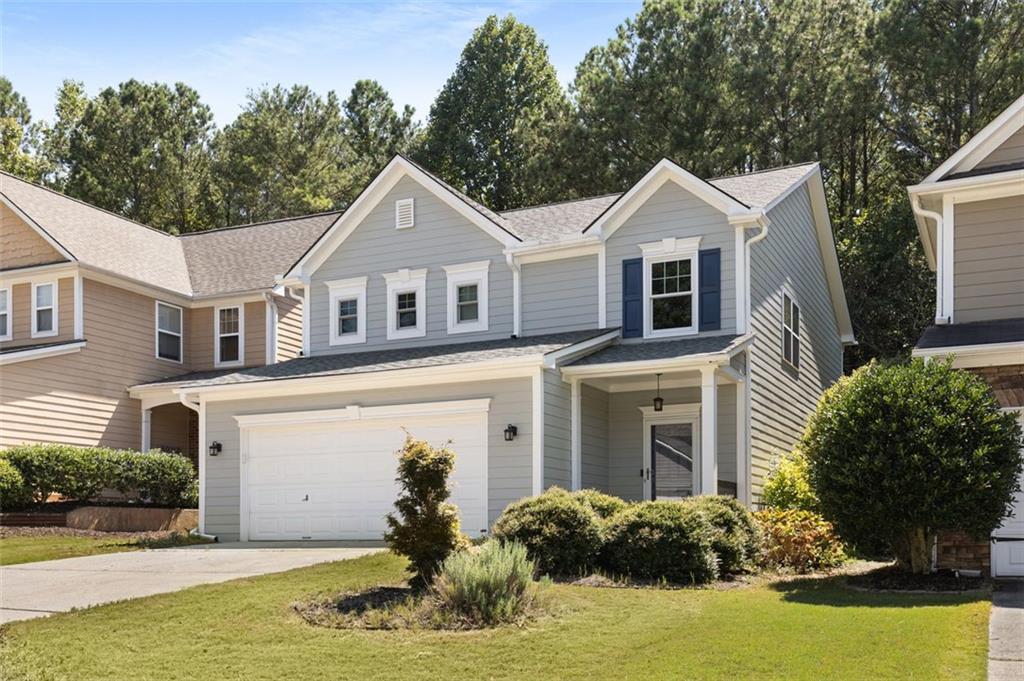 a front view of a house with a yard and garage