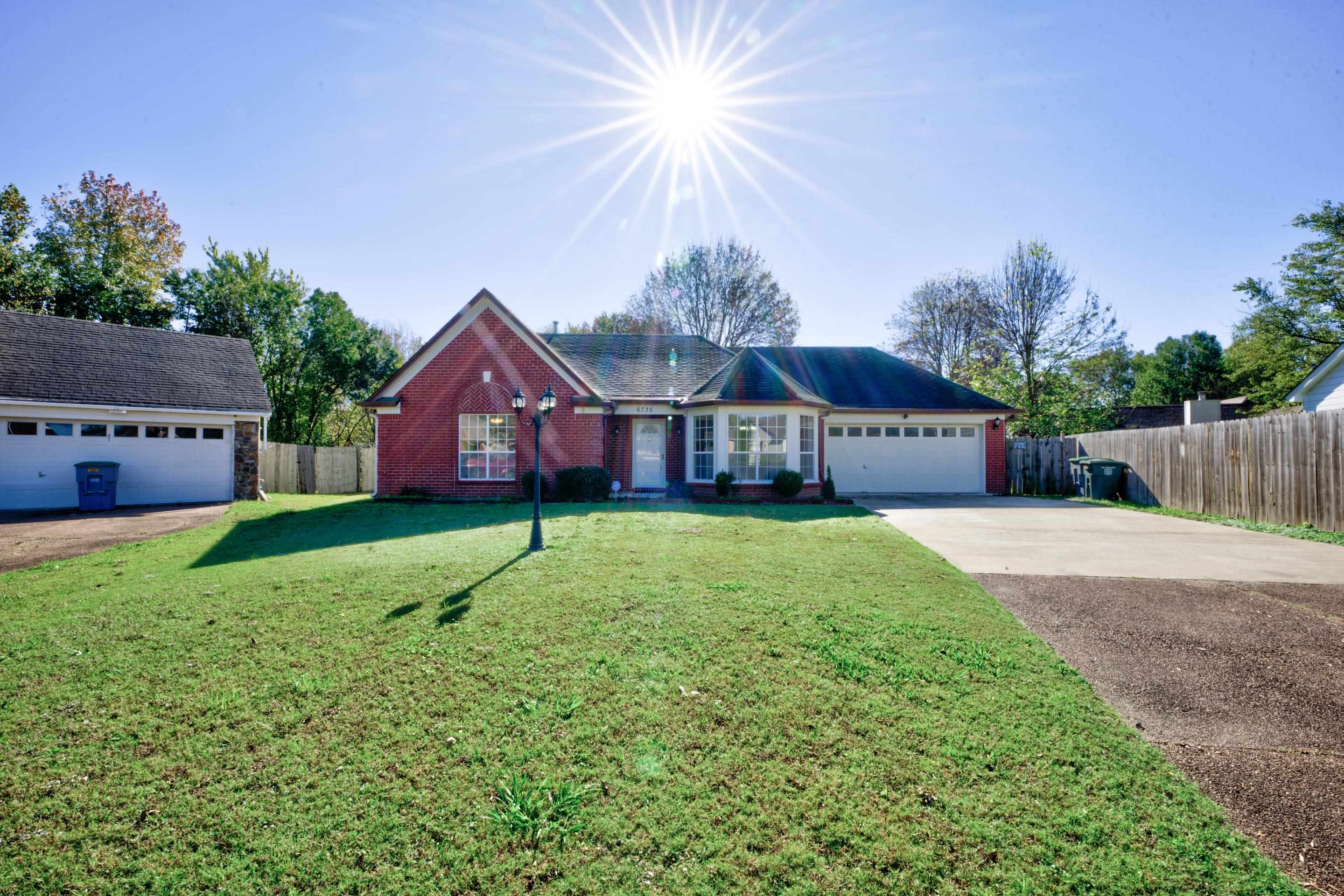 Ranch-style home with a front yard and a garage