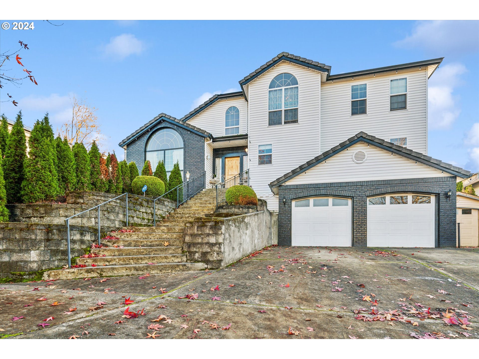 a front view of a house with a yard and garage