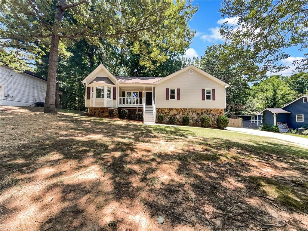 a front view of a house with a yard and trees