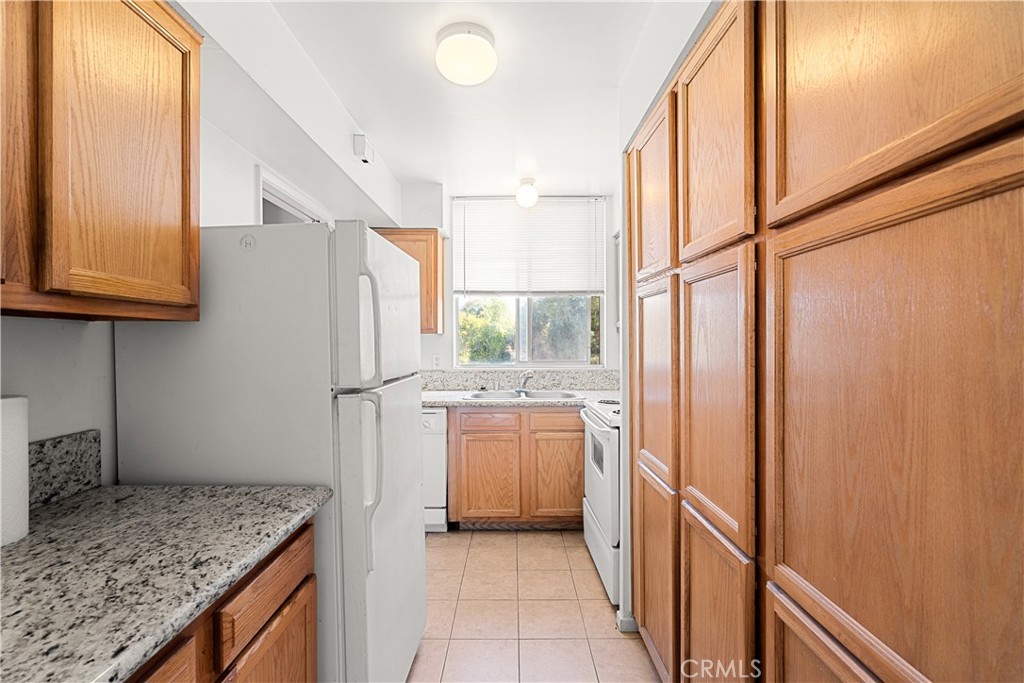 a kitchen with a refrigerator and a sink