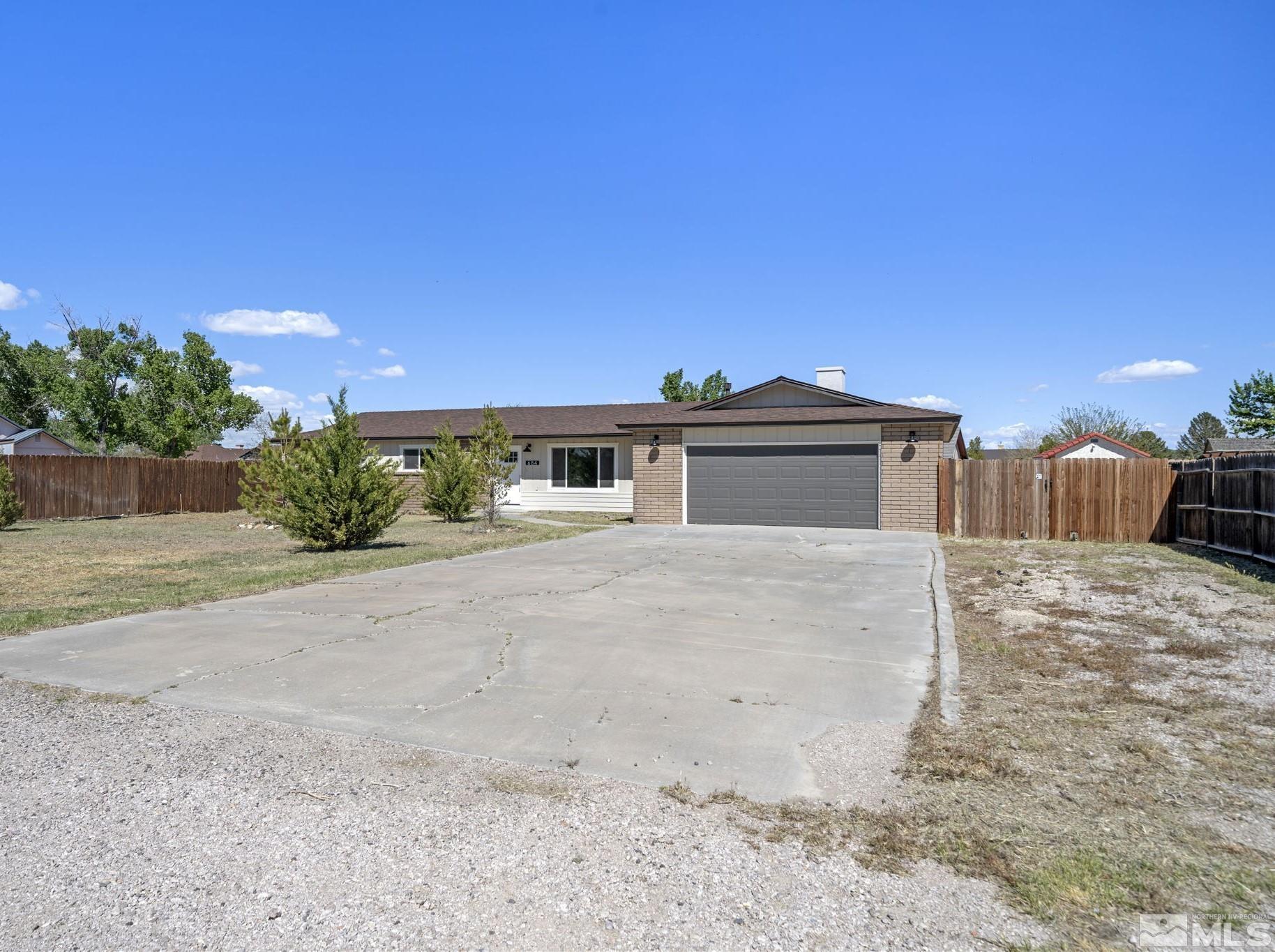 a front view of a house with a yard and a garage