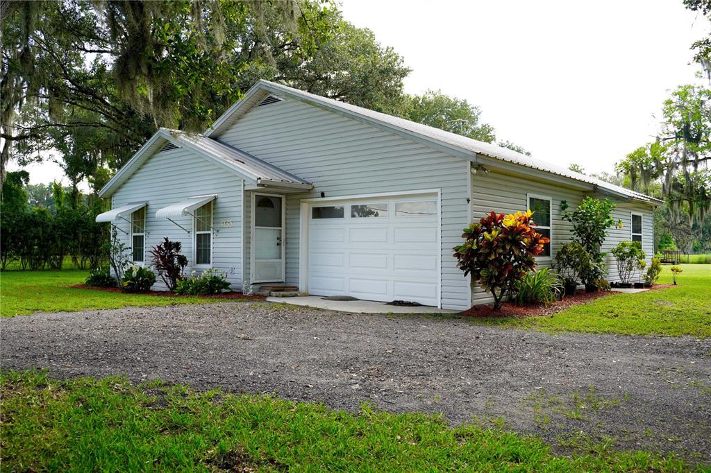 a front view of house with yard and green space